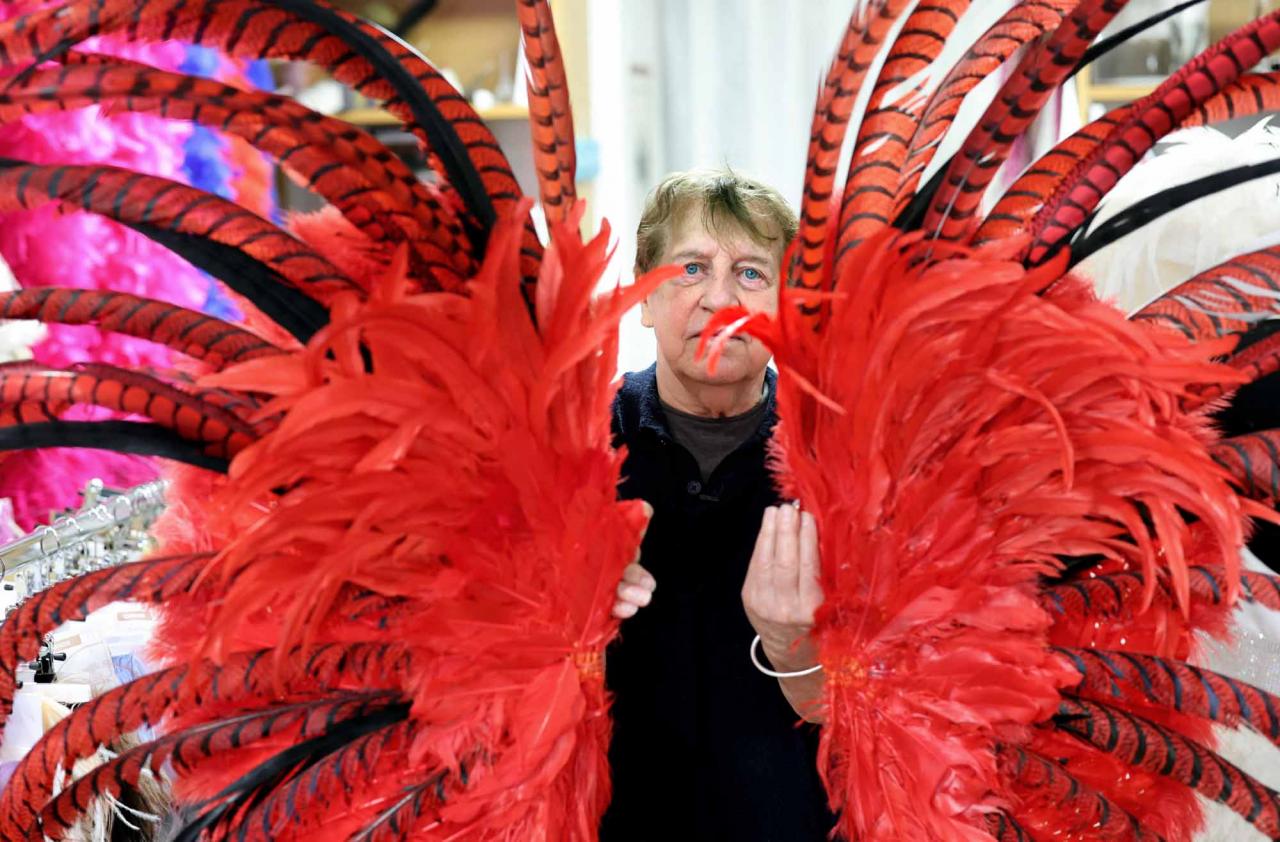 Dominique De Roo, official feather craftsman of the Lido cabaret poses inside his workshop in Paris on June 1, 2022. - The Lido cabaret, an institution for Parisian night life since 1889, is set to lay off 157 of 184 employees, including its "Bluebell girls" troupe of dancers, announced the new owner, French hotels giant Accor. (Photo by Thomas COEX / AFP)