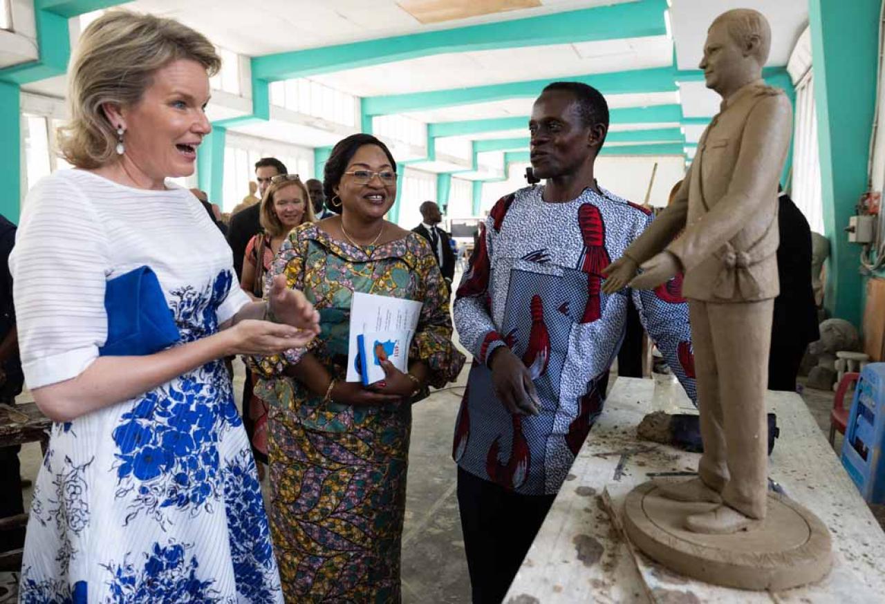Queen Mathilde inspects a miniature sculpture of King Philippe - Filip at a round table discussion on women's rights at the Academie des Beaux-Arts, during an official visit of the Belgian Royal couple to the Democratic Republic of Congo, Thursday 09 June 2022, in Kinshasa. The Belgian King and Queen will be visiting Kinshasa, Lubumbashi and Bukavu from June 7th to June 13th. BELGA PHOTO BENOIT DOPPAGNE