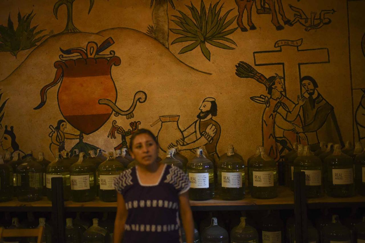 Graciela Angeles Carreno, who leads a family business of four generations, shows the cellar at their Real Minero mezcal factory in Santa Catarina Minas, Oaxaca State, Mexico, on July 25, 2022. - Craft distillers fear mezcal will become victim of its own success. The fast-growing popularity of Tequila's lesser-known cousin is raising concerns about its sustainability as strong demand means that more land, water and firewood are needed to grow the agave plants and distill the smoky spirit. Faced with the boom, craft producers are committed to saving wild species by planting them and showcasing the artisanal process behind the liquor. (Photo by Pedro PARDO / AFP)
