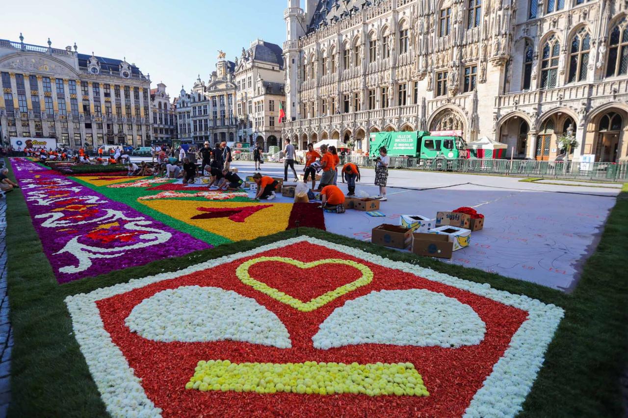 (220812) -- BRUSSELS, Aug. 12, 2022 (Xinhua) -- People prepare the flower carpet at the Grand Place in Brussels, Belgium, Aug. 12, 2022. After the cancellation of the Flower Carpet 2020 due to the COVID-19 pandemic, the traditional festival returned to Brussels from August 12 to 15, 2022. The theme of the Flower Carpet 2022 is "50th Anniversary of the Brussels Flower Carpet". Artists reinterpret the design of the pattern of the first flower carpet in 1971, using about 140,000 begonias, 225,000 dahlias, dyed bark, rolls of turf, chrysanthemums and euonymus. (Xinhua/Zheng Huansong)