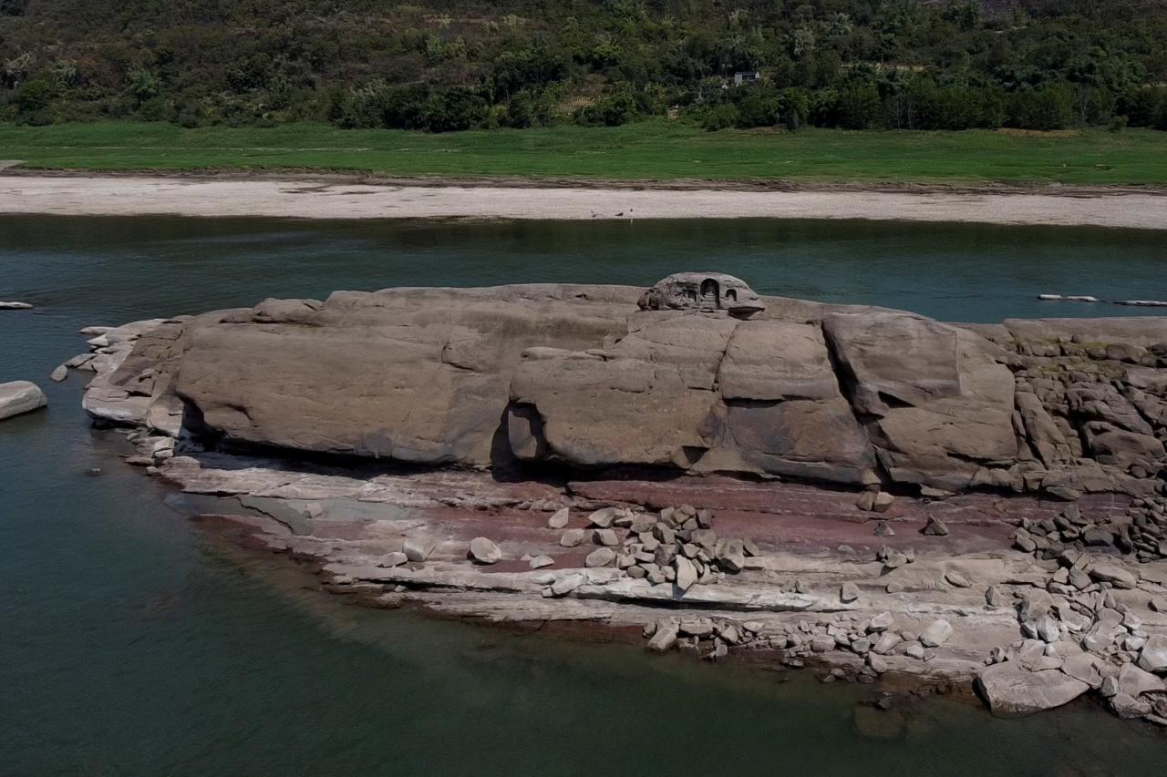 A once submerged Buddhist statue sits on top of Foyeliang island reef in the Yangtze river, which appeared after water levels fell due to a regional drought in Chongqing, China, in this screengrab obtained from a video taken with a drone, August 20, 2022. REUTERS/Thomas Suen