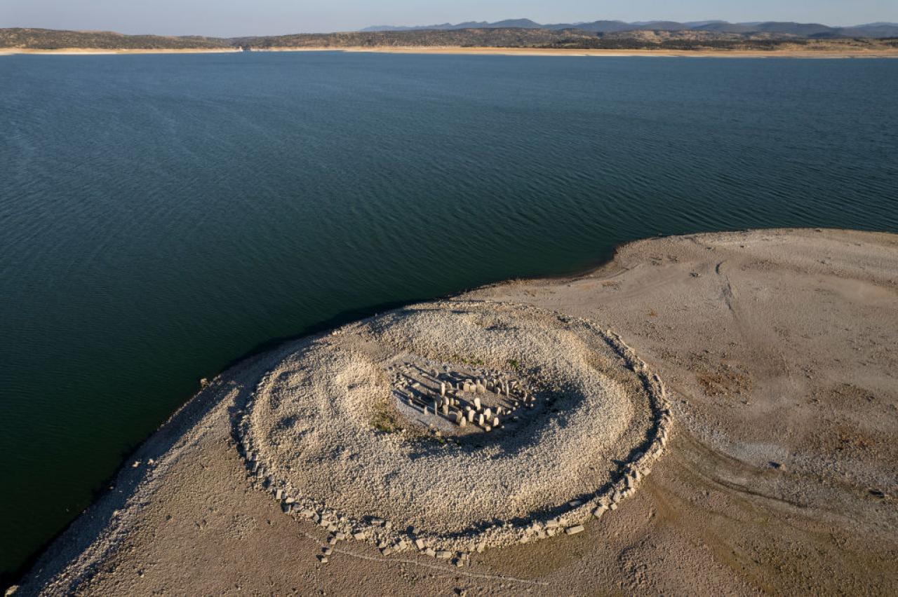 CACERES, SPAIN - JULY 28: The Dolmen of Guadalperal, sometimes also known as "The Spanish Stonehenge" is seen above the water level at the Valdecanas reservoir, which is at 27 percent capacity, on July 28, 2022 in Caceres province, Spain. Some areas of Europe are at risk of drought following a lack of precipitation and severe heatwaves. Spain is battling one of the driest weather conditions in a long time, which could lead to implications for agriculture and tourism, with some areas already facing water restrictions. (Photo by Pablo Blazquez Dominguez/Getty Images)