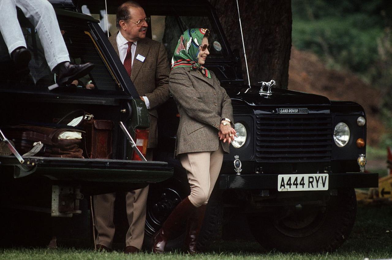 WINDSOR, UNITED KINGDOM - MAY 13:  The Queen Wearing Jodhpurs And A Headscarf At The Windsor Horse Show With Her Friend Count Andraxy From Liechtenstein. They Are Standing By The Queens Land Rover Defender Four-wheel Drive Car  (Photo by Tim Graham Photo Library via Getty Images)