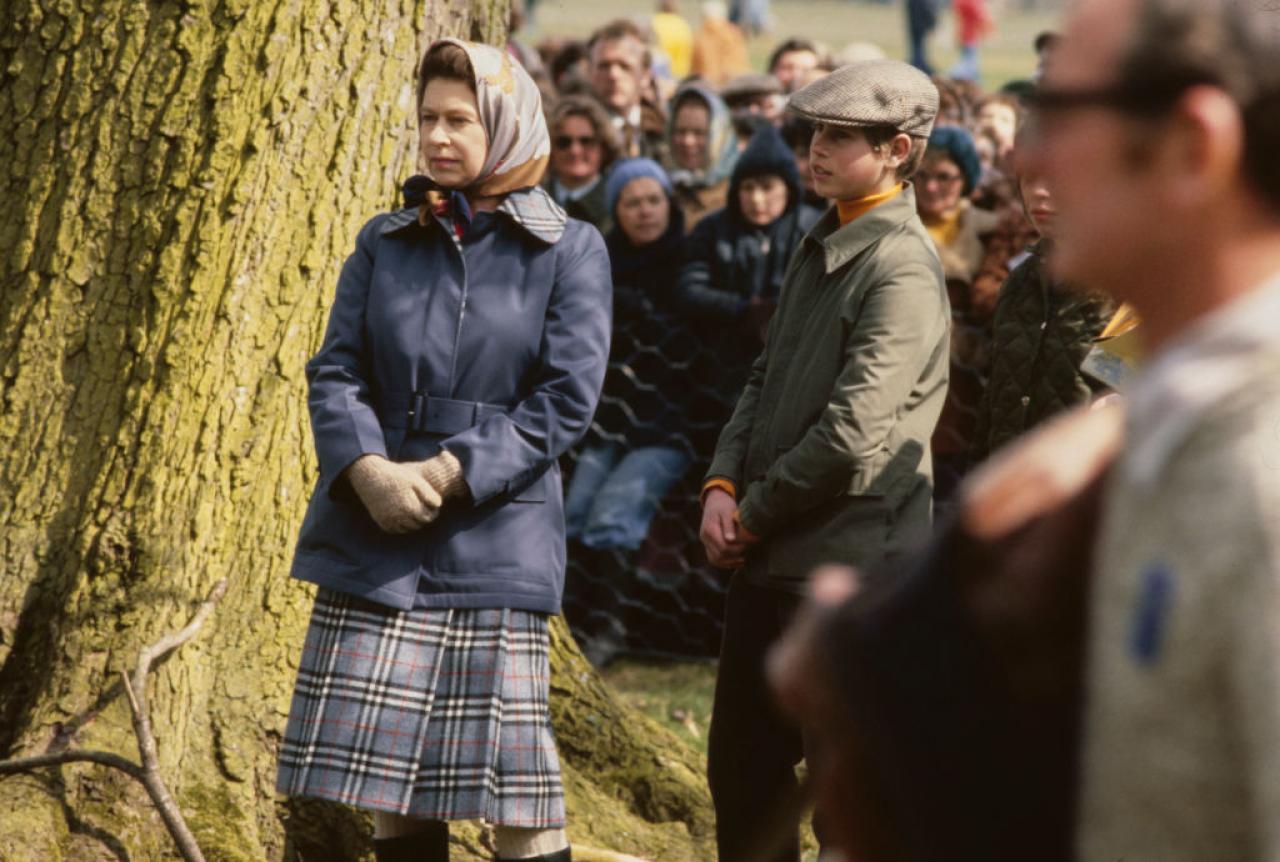 British Royals Queen Elizabeth II, wearing a blue coat with a headscarf, and her son, Prince Edward, attend Badminton Horse Trials, held in the grounds of Badminton House, Badminton, Gloucestershire, England, April 1978. (Photo by Serge Lemoine/Hulton Archive/Getty Images)