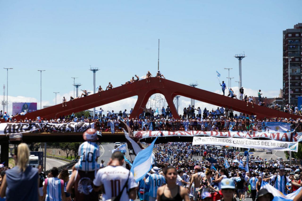 Fans of Argentina wave flags as part of celebrations awaiting a victory parade of the Argentina men's national football team after winning the FIFA World Cup Qatar 2022 on December 20, 2022 in Buenos Aires, Argentina. (Photo by Carol Smiljan/NurPhoto via Getty Images)