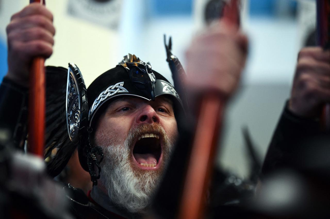 Members of the Up Helly Aa 'Jarl Squad' prepare to parade through the streets of in Lerwick, Shetland Islands on January 31, 2023 before the Up Helly Aa festival later in the day. - Up Helly Aa celebrates the influence of the Scandinavian Vikings in the Shetland Islands and culminates with up to 1,000 'guizers' (men in costume) throwing flaming torches into their Viking longboat and setting it alight later in the evening. (Photo by Andy Buchanan / AFP)