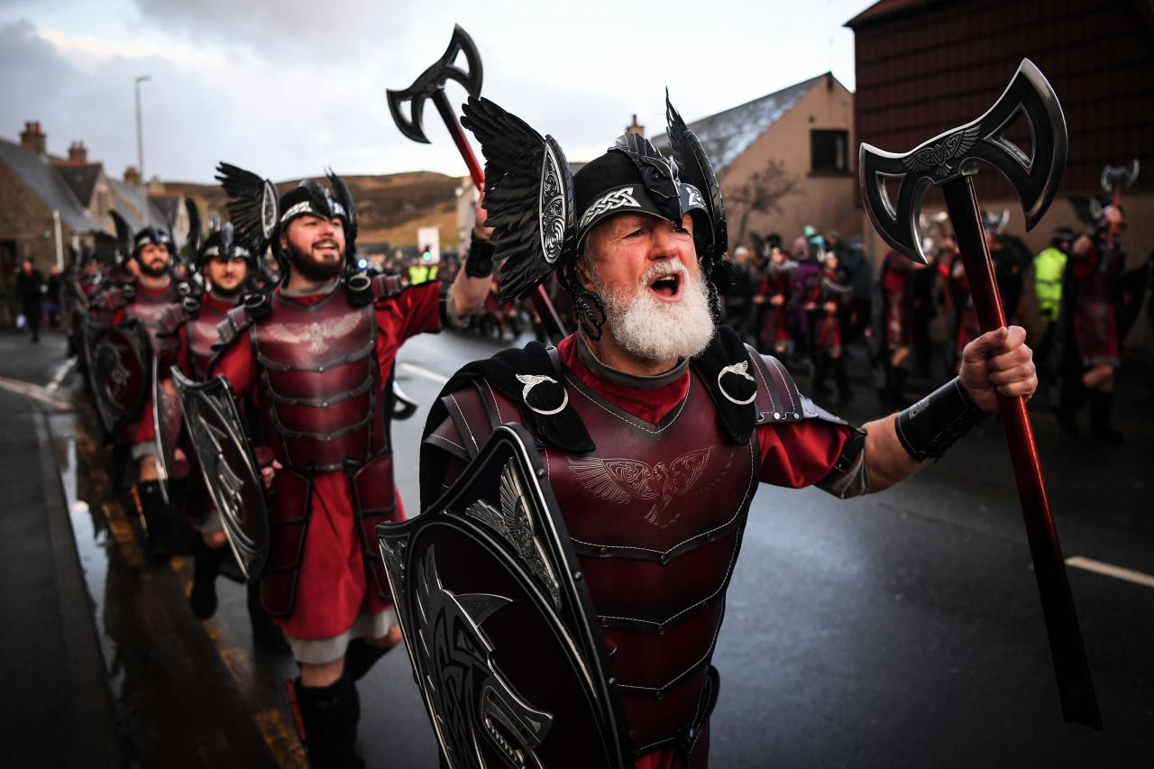 Members of the Up Helly Aa 'Jarl Squad' parade through the streets in Lerwick, Shetland Islands on January 31, 2023 before the Up Helly Aa festival later in the day. - Up Helly Aa celebrates the influence of the Scandinavian Vikings in the Shetland Islands and culminates with up to 1,000 'guizers' (men in costume) throwing flaming torches into their Viking longboat and setting it alight later in the evening. (Photo by Andy Buchanan / AFP)