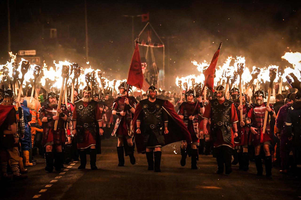 Participants take part in the Up Helly Aa festival parade through the streets of Lerwick, Shetland Islands on January 31, 2023. - Up Helly Aa celebrates the influence of the Scandinavian Vikings in the Shetland Islands and culminates with up to 1,000 'guizers' (men in costume) throwing flaming torches into their Viking longboat and setting it alight later in the evening. (Photo by Andy Buchanan / AFP)
