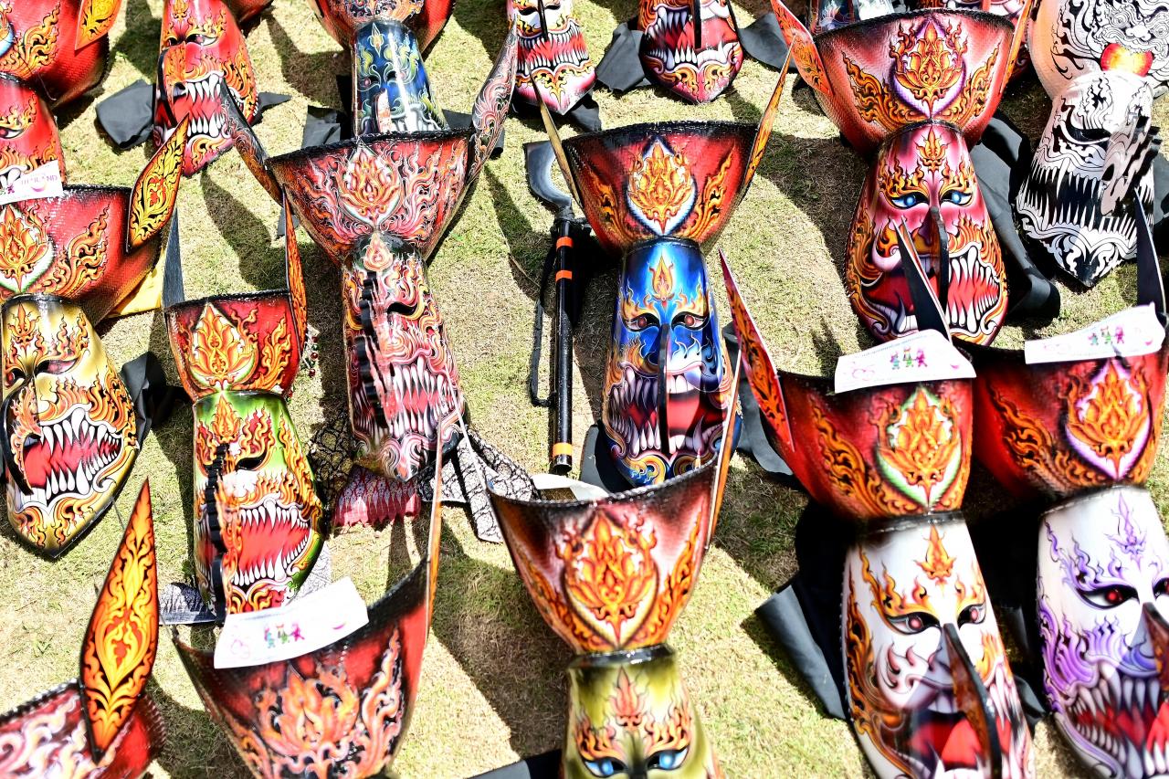 Elaborate long-nosed ghost masks are seen on the ground ahead of a parade during the annual Phi Ta Khon carnival or ghost festival in Dan Sai district in northeastern Thailands Loei Province on June 24, 2023. (Photo by MANAN VATSYAYANA / AFP)