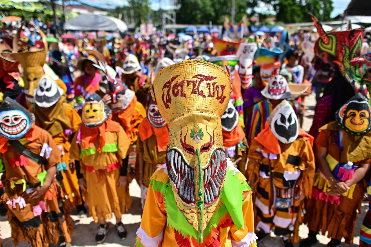 Participants wearing ghost masks and colorful costumes take part in the annual Phi Ta Khon carnival or ghost festival in Dan Sai district in northeastern Thailands Loei Province on June 24, 2023. (Photo by MANAN VATSYAYANA / AFP)