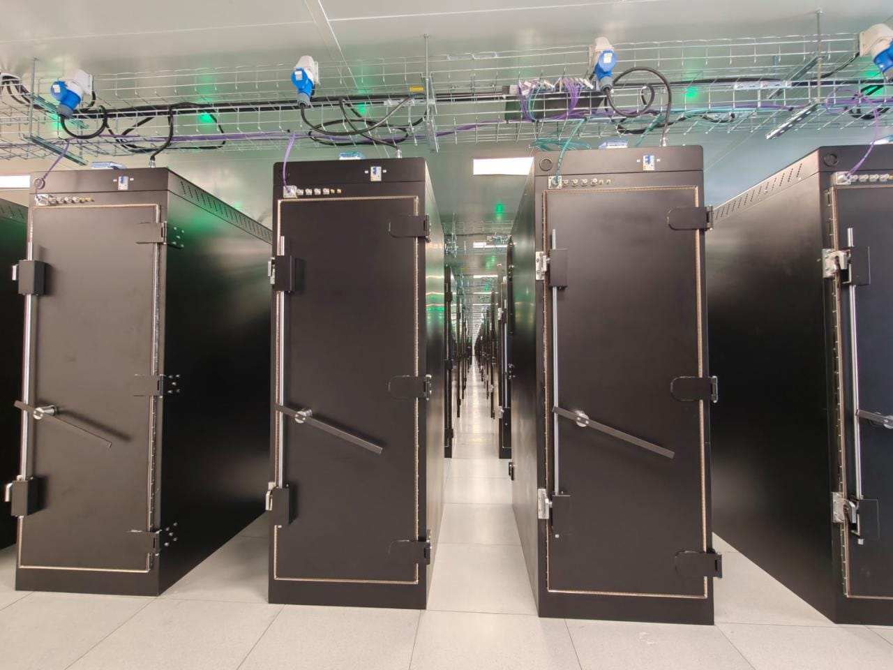 Verspreid over 200 cabinets worden hier om en nabij de 20.000 smartphones simultaan getest.