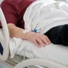 Patiënt ligt in ziekenhuisbed.