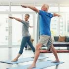 Full length shot of an active senior couple exercising together inside their home