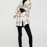 Manteau court noir et blanc à carreaux