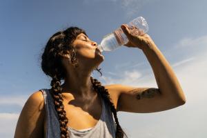 Mid adult woman drinking water outdoors