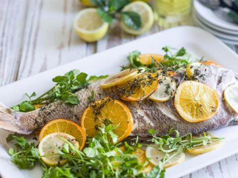 Red snapper with lemons, oranges and fresh herbs