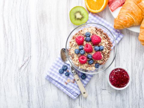 Muesli with fresh fruit on a breakfast table; Shutterstock ID 259697921
