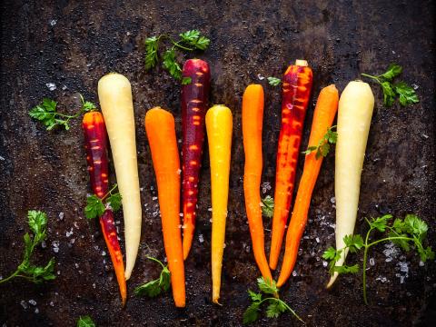 raw rainbow carrot for roasting, on a baking tray; Shutterstock ID 305058122
