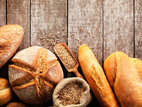 Assortment of baked bread on wooden table background; Shutterstock ID 278970809