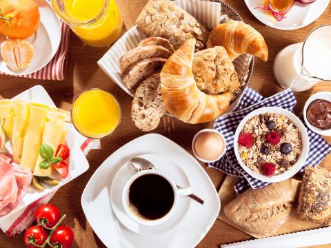Top view of coffee, juice, fruit, bread and meat on table; Shutterstock ID 359916206