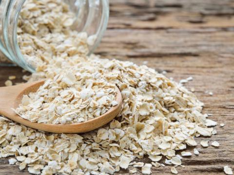 Dry rolled oat flakes oatmeal on old wooden table; Shutterstock ID 288751613