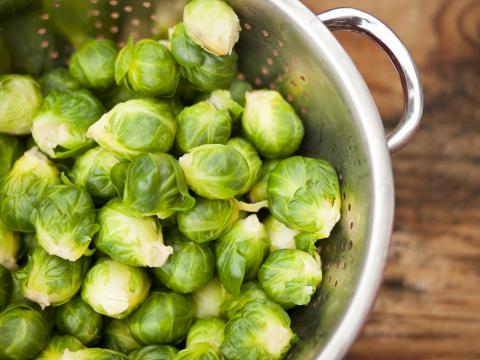 Uncooked brussels sprouts in a colander
