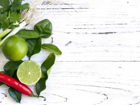 Kaffir lime leaves, fruit, coriander or cilantro, red chilli and green onions over white distressed wooden background. Overhead view.; Shutterstock ID 275069288; Projectnummer: B09773 ; Uitgave: Libelle Lekker; Traffic: Rien Delvaux; Anders: /