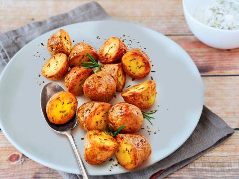 25964469 - roasted potatoes with herbs and spices, food closeup