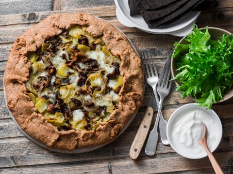Wild mushrooms, potatoes, mozzarella, whole grain galette with greek yoghurt and green salad on a wooden rustic background, top view. Flat lay.; Shutterstock ID 763775200