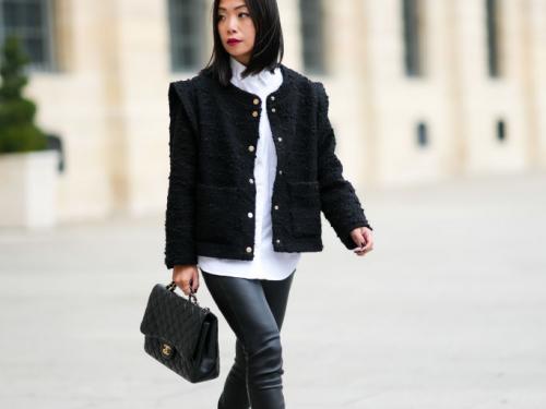 PARIS, FRANCE - OCTOBER 01: May Berthelot wears a white shirt, a black tweed jacket with epaulets, black shiny leather skinny pants, a black shiny leather Chanel handbag, a silver ring, a gold Juste Un Clou ring form Cartier, black shiny leather pointed block heels ankle boots from Yves Saint Laurent / YSL, during Paris Fashion Week - Womenswear Spring Summer 2022, on October 01, 2021 in Paris, France. (Photo by Edward Berthelot/Getty Images)