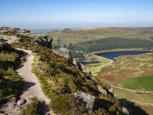 Gritstone outcrops in the hills above Dove Stone and Yeoman Hey reservoirs in the north of the Peak District national park, England.