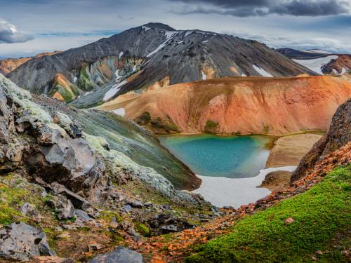 Panoramic view of colorful rhyolite volcanic mountains Landmannalaugar as pure wilderness in Iceland and a hidden highland lake, Iceland, summer time