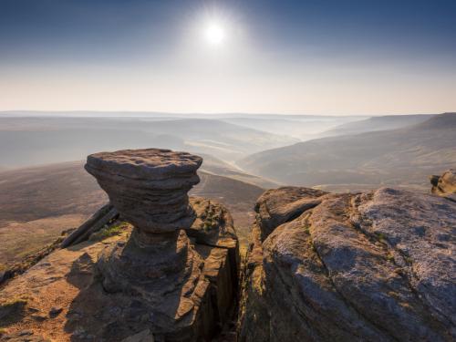 Rocks on the North side of Kinder Scout mountain with a stunning sunrise. English Peak District National park. UK.