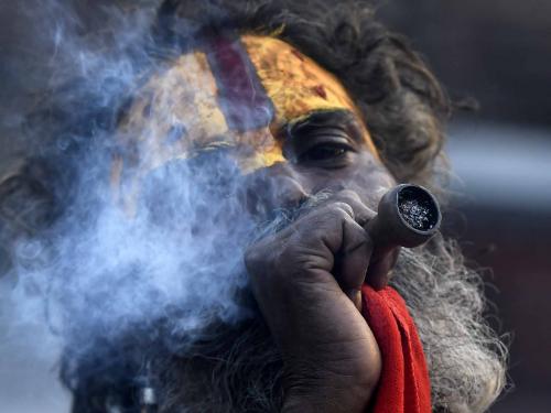 This photograph taken on April 27, 2022, shows a Sadhu (Hindu holy man) smoking marijuana using a traditional clay pipe at Pashupatinath Temple in Kathmandu. - Nepal's marijuana ban could soon be up in smoke, as lawmakers mull a return to the liberal drug policies that once made the Himalayan republic a popular pit stop on the overland "Hippie Trail". (Photo by Prakash MATHEMA / AFP) / TO GO WITH 'Nepal-law-cannabis-drugs' FOCUS
