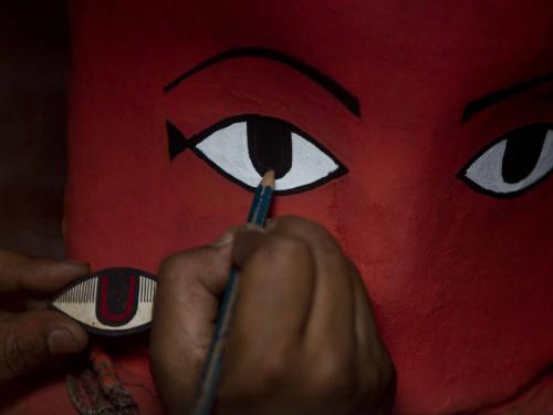 (220427) -- LALITPUR, April 27, 2022 (Xinhua) -- A priest paints an idol ahead of Rato Machendranath chariot festival in Lalitpur, Nepal, April 27, 2022. (Photo by Sulav Shrestha/Xinhua)