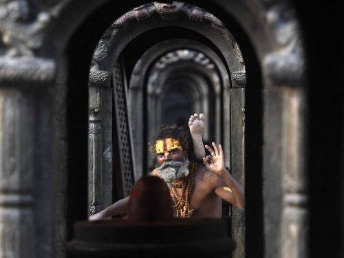 A Sadhu or Hindu holy man poses for picture at the Pashupatinath temple area in Kathmandu on April 27, 2022. (Photo by PRAKASH MATHEMA / AFP)
