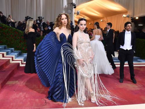 US actress Dove Cameron (R) and Dutch designer Iris Van Herpen arrives for the 2022 Met Gala at the Metropolitan Museum of Art on May 2, 2022, in New York. - The Gala raises money for the Metropolitan Museum of Art's Costume Institute. The Gala's 2022 theme is "In America: An Anthology of Fashion". (Photo by ANGELA  WEISS / AFP)