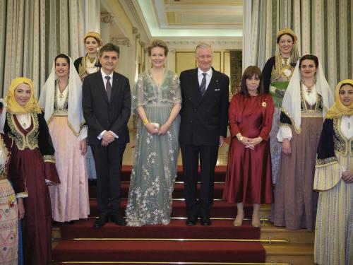 Pavolos Kotsonis, partner of HE President Sakellaropoulou, Queen Mathilde of Belgium, King Philippe - Filip of Belgium and President of Greece Katerina Sakellaropoulou pose for the photographer with women dressed in traditional Greek costumes, at the start of a state dinner with president Sakellaropoulou on the first day of a three days state visit of the Belgian royal couple to Greece, Monday 02 May 2022, in Athens.BELGA PHOTO POOL OLIVIER POLET