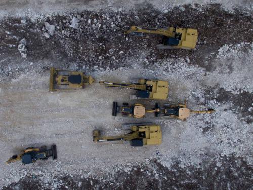 Aerial view showing heavy machinery parked at the construction site of Section 5 South of the Mayan Train between the resorts of Playa del Carmen and Tulum which was halted by a district judge pending resolution of an injunction sought by scuba divers and environmentalists -- in Playa del Carmen, Quintana Roo State, Mexico, on April 26, 2022. - A Mexican judge earlier this month suspended construction of part of President Andres Manuel Lopez Obrador's flagship tourist train project in the Yucatan peninsula due to a lack of environmental impact studies. The Mayan Train, a roughly 1,500-kilometre (950 mile) rail loop linking popular Caribbean beach resorts and archeological ruins, has met with opposition from environmentalists and indigenous communities. (Photo by Pedro PARDO / AFP)