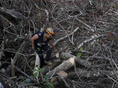Activist and speleologist Tania Ramirez walks out of a cave known as Dama Blanca (White Lady) in the construction site of Section 5 South of the Mayan Train between the resorts of Playa del Carmen and Tulum which was halted by a district judge pending resolution of an injunction sought by scuba divers and environmentalists -- in the jungle in Playa del Carmen, Quintana Roo State, Mexico, on April 27, 2022. - A Mexican judge earlier this month suspended construction of part of President Andres Manuel Lopez Obrador's flagship tourist train project in the Yucatan peninsula due to a lack of environmental impact studies. The Mayan Train, a roughly 1,500-kilometre (950 mile) rail loop linking popular Caribbean beach resorts and archeological ruins, has met with opposition from environmentalists and indigenous communities. (Photo by Pedro PARDO / AFP)
