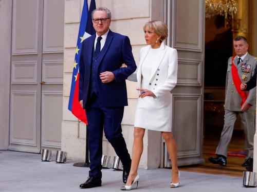 President of the French national assembly Richard Ferrand (L) and French President's wife Brigitte Macron (R) arrive at the Elysee presidential palace in Paris on May 7, 2022, to attend the investiture ceremony of Emmanuel Macron as French President, following his re-election last April 24. (Photo by GONZALO FUENTES / POOL / AFP)