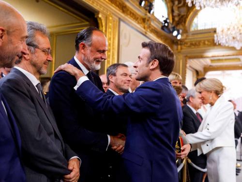 Edouard Philippe, Le Havre mayor and former French Prime Minister, shakes hands with French President Emmanuel Macron after he is sworn-in for a second term as president following his re-election on April 14, during a ceremony at the Elysee Palace in Paris, on May 7, 2022. (Photo by GONZALO FUENTES / POOL / AFP)