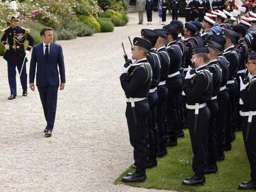 Emmanuel Macron (2L) reviews troops at the Elysee presidential palace in Paris on May 7, 2022, during his investiture ceremony as French President, following his re-election last April 24. (Photo by Ludovic MARIN / AFP)