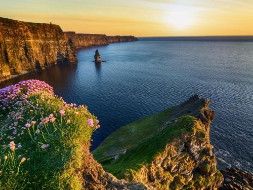 epic sunset at the cliffs of moher in county clare, ireland. beautiful evening scenic view from the wild atlantic way