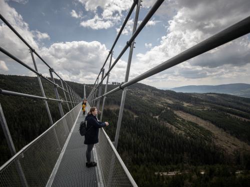 DOLNI MORAVA, CZECH REPUBLIC - MAY 9: Visitors watch the environment on the Sky Bridge 721, the world's longest suspension pedestrian bridge in Dolni Morava, Czech Republic on May 9, 2022. Sky Bridge 721, the longest pedestrian bridge in the world with a length of 721 meters and an elevation of 95 meters above the ground, is located in the Pardubice region (a break between the Eagle Mountains and the Jesenice). (Photo by Lukas Kabon/Anadolu Agency via Getty Images)