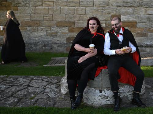 Vampires pose for a photograph in the grounds of Whitby Abbey during a Guinness world record attempt to gather the largest number of vampires together in one place, in Whitby, north-east England on May 26, 2022. - The world record attempt takes place on the 125th anniversary of the first publication of Bram Stoker's novel 'Dracula'. Stoker visited Whitby in 1890 and it's understood that the town and 13th century gothic ruins of the Abbey provided inspiration for Dracula. The current record saw 1039 vampires gather at Doswell in Virginia, USA in 2011. (Photo by Oli SCARFF / AFP)