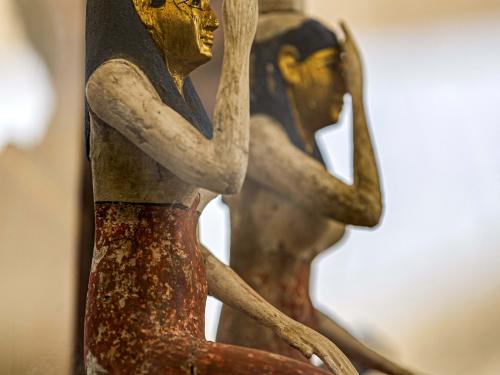Statuettes depicting the Egyptian goddesses (L to R) Isis (Iset) and Nephthys (Nebet-Het) found in a cache dating to the Egyptian Late Period (around the fifth century BC) are displayed after their discovery by a mission headed by Egypt's Supreme Council of Antiquities, at the Bubastian cemetery at the Saqqara necropolis, southwest of Egypt's capital on May 30, 2022. - Egypt on May 30 unveiled a cache of 150 bronze statues depicting various gods and goddesses including "Bastet, Anubis, Osiris, Amunmeen, Isis, Nefertum and Hathor," along with 250 sarcophagi at the Saqqara archaeological site south of Cairo, the latest in a series of discoveries in the area. (Photo by Khaled DESOUKI / AFP)