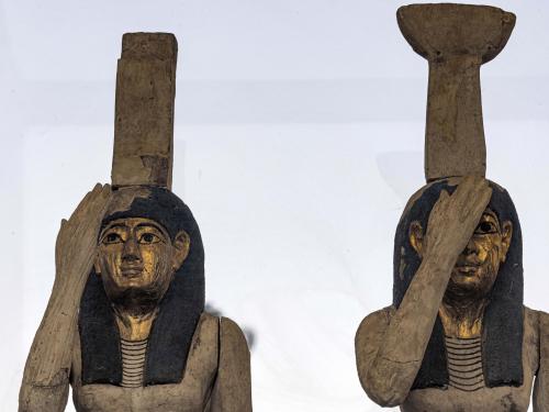 Statuettes depicting the Egyptian goddesses (L to R) Isis (Iset) and Nephthys (Nebet-Het) found in a cache dating to the Egyptian Late Period (around the fifth century BC) are displayed after their discovery by a mission headed by Egypt's Supreme Council of Antiquities, at the Bubastian cemetery at the Saqqara necropolis, southwest of Egypt's capital on May 30, 2022. - Egypt on May 30 unveiled a cache of 150 bronze statues depicting various gods and goddesses including "Bastet, Anubis, Osiris, Amunmeen, Isis, Nefertum and Hathor," along with 250 sarcophagi at the Saqqara archaeological site south of Cairo, the latest in a series of discoveries in the area. (Photo by Khaled DESOUKI / AFP)
