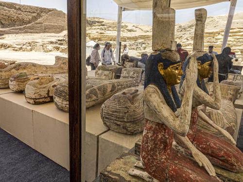 Statuettes depicting the Egyptian goddesses (L to R) Isis (Iset) and Nephthys (Nebet-Het) and other sarcophaguses found in a cache dating to the Egyptian Late Period (around the fifth century BC) are displayed after their discovery by a mission headed by Egypt's Supreme Council of Antiquities, at the Bubastian cemetery at the Saqqara necropolis, southwest of Egypt's capital on May 30, 2022. - Egypt on May 30 unveiled a cache of 150 bronze statues depicting various gods and goddesses including "Bastet, Anubis, Osiris, Amunmeen, Isis, Nefertum and Hathor," along with 250 sarcophagi at the Saqqara archaeological site south of Cairo, the latest in a series of discoveries in the area. (Photo by Khaled DESOUKI / AFP)
