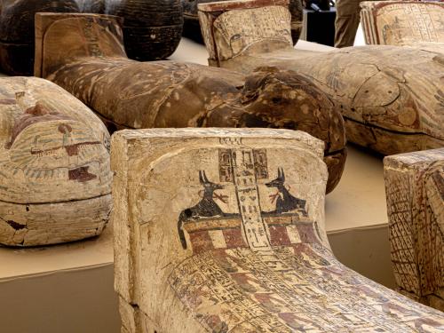 Sarcophaguses found in a cache dating to the Egyptian Late Period (around the fifth century BC) are displayed after their discovery by a mission headed by Egypt's Supreme Council of Antiquities, at the Bubastian cemetery at the Saqqara necropolis, southwest of Egypt's capital on May 30, 2022. - Egypt on May 30 unveiled a cache of 150 bronze statues depicting various gods and goddesses including "Bastet, Anubis, Osiris, Amunmeen, Isis, Nefertum and Hathor," along with 250 sarcophagi at the Saqqara archaeological site south of Cairo, the latest in a series of discoveries in the area. (Photo by Khaled DESOUKI / AFP)